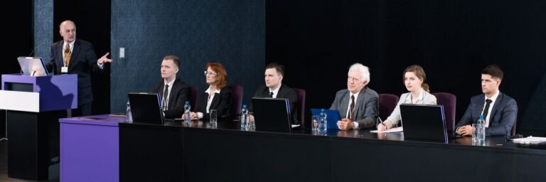Panel on stage with a speaker at the podium
