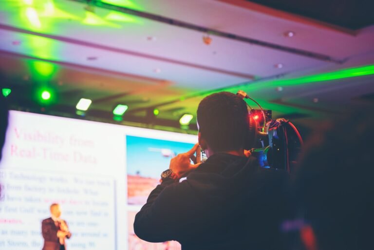 Camera operator filming a keynote presenter
